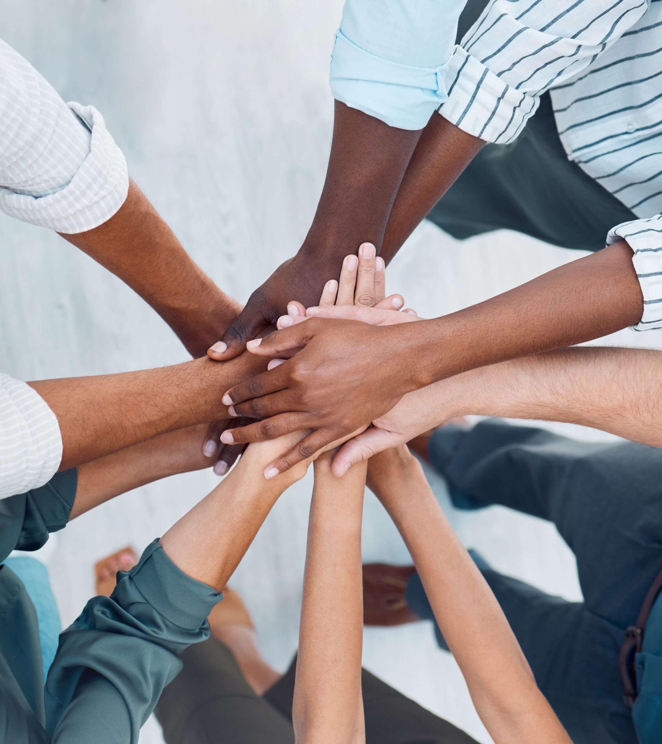 Diversity, hands and team above in support, trust and unity for collaboration, agreement or meeting at the office. Group hand of diverse people in teamwork, cooperation and solidarity for community Pile of hands